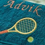 Petrol blue towel with embroidered tennis racket, ball and custom name