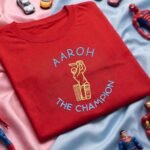 Cricket Batsman design embroidered red kids tshirt, folded flat lay