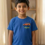 Smiling boy wearing a royal blue t-shirt with small SUV embroidery and custom name Arjun on the left chest